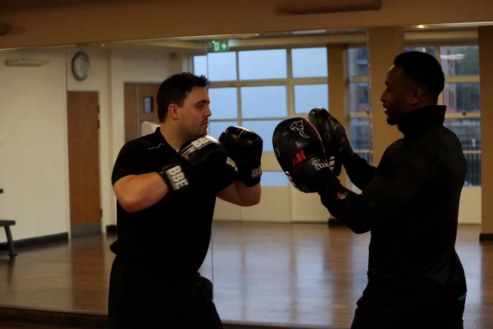 James holding pads for a client